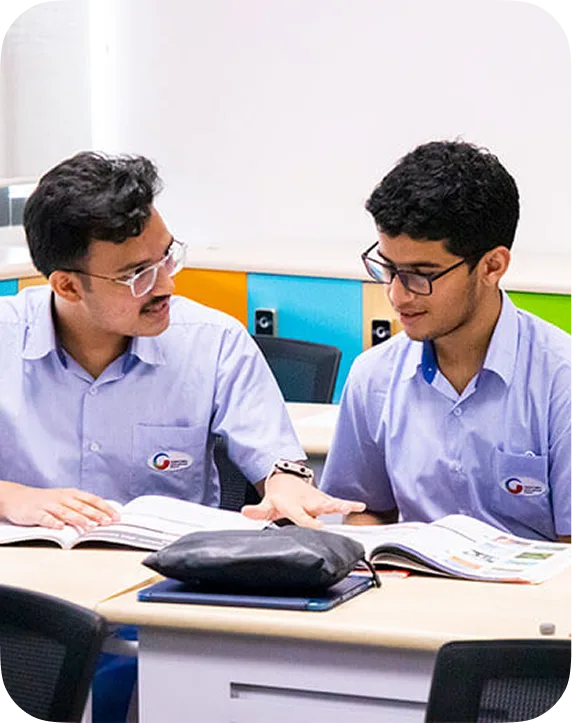 Teacher and student studying together at a desk